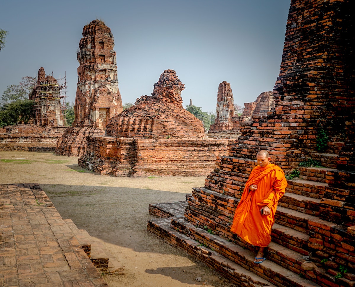 a monk walking down from the temple