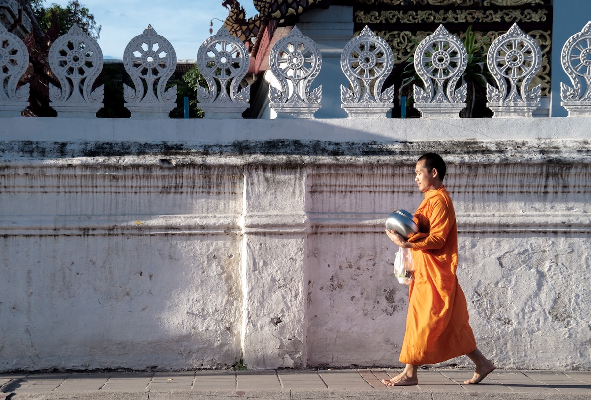 a monk walking down the street 