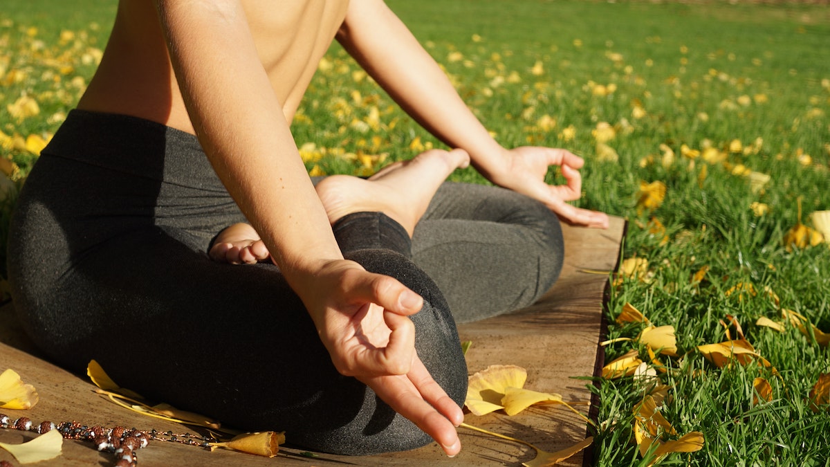 Woman meditating to open her solar plexus chakra