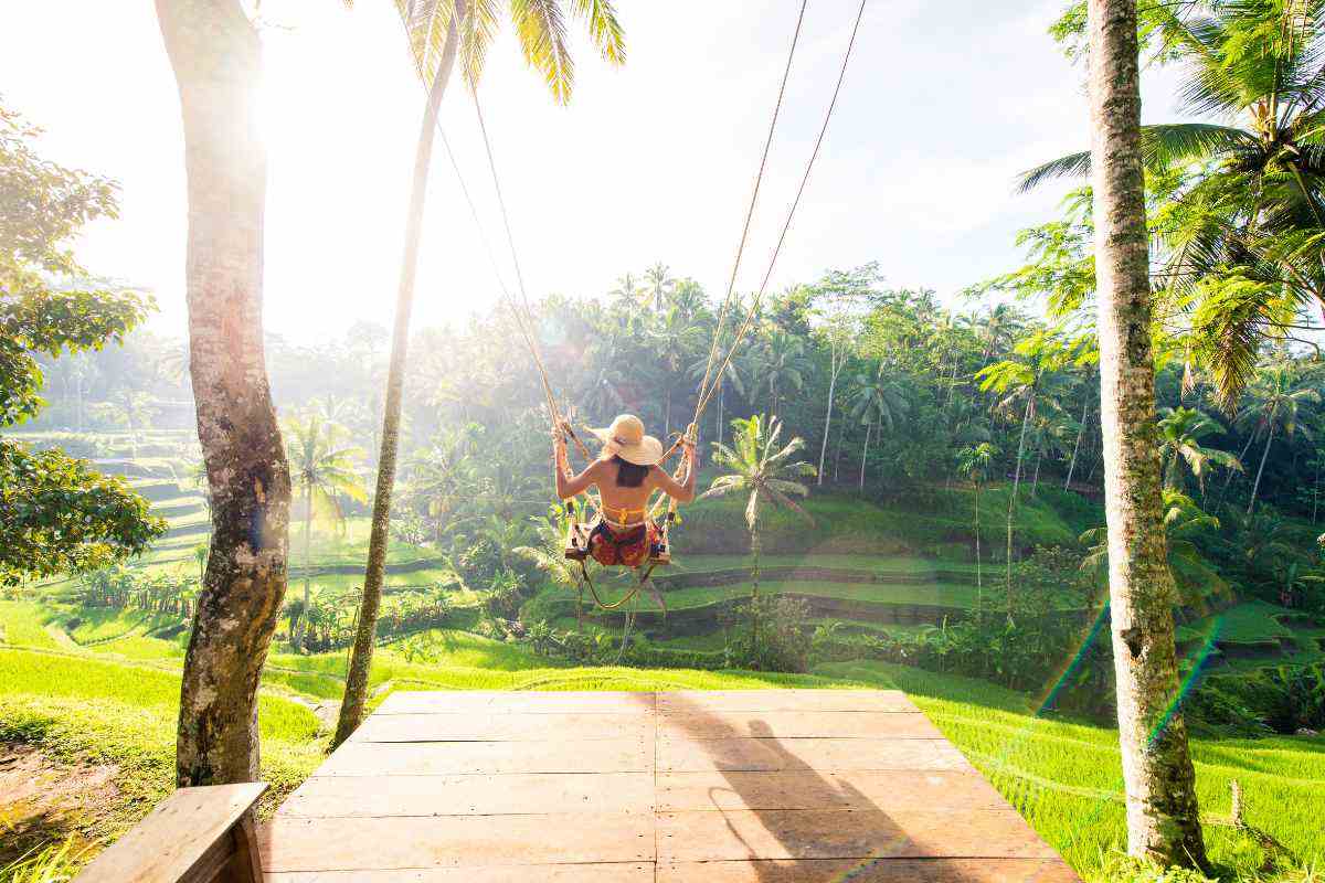 Woman on a swing in Bali, contemplating whether she needs Lifebook Online
