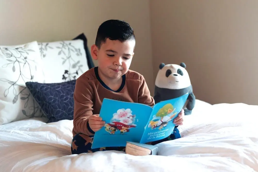 Child reading in bed