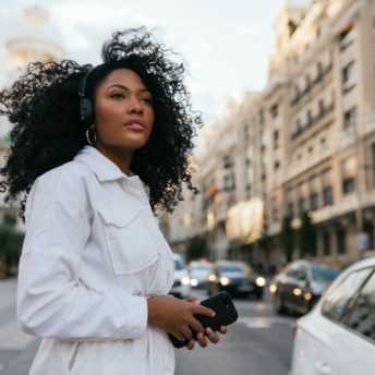 Woman listening to podcasts and looking around the city