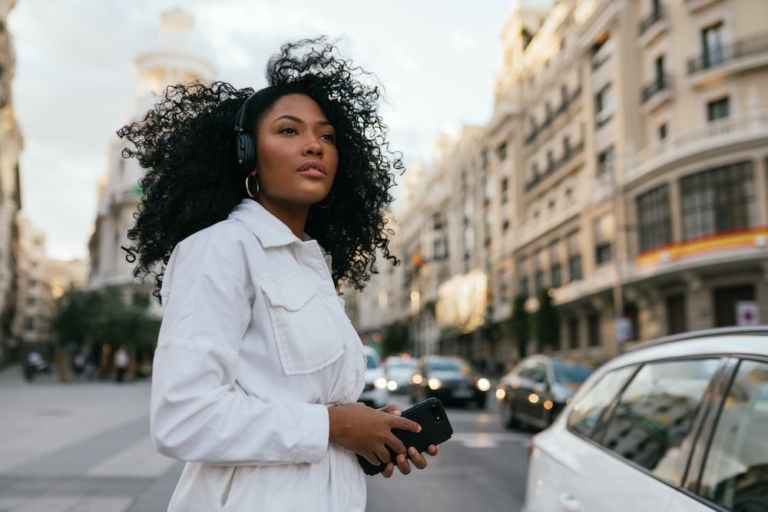 Woman listening to podcasts and looking around the city