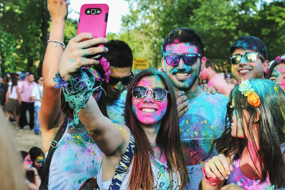 Friends taking a photo of themselves during a color run