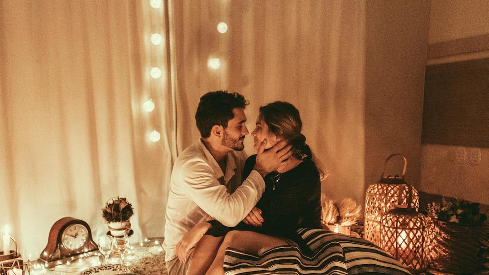 Couple in embrace under romantic lights