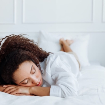 Woman laying on her stomach in bed