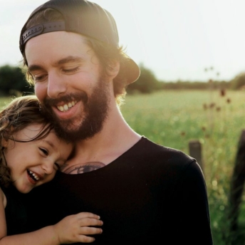 Father and daughter embracing in optimism