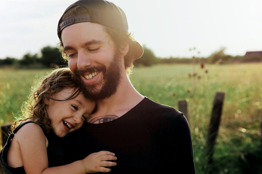 Father and daughter embracing in optimism