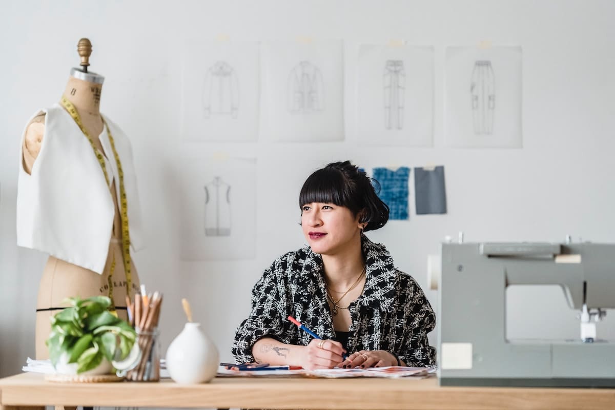 Fashion designer thinking of how to turn her business ideas for women into a profit