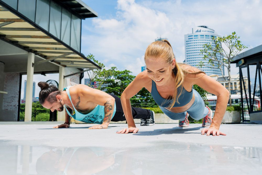 Mindvalley's 10x trainers doing push-ups for muscular endurance