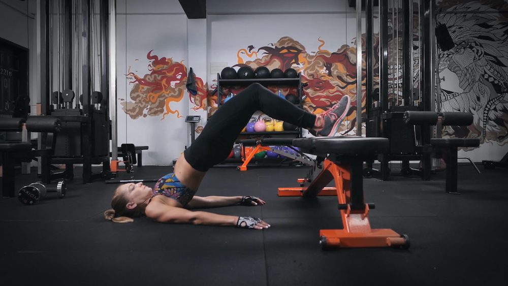 Woman doing elevated glute bridge