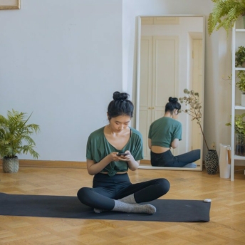 Woman using free meditation apps on her phone