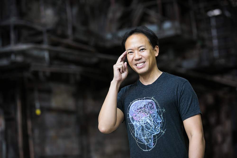 Brain coach, Jim Kwik, with fingers at his temple with his thoughts on memory supplements