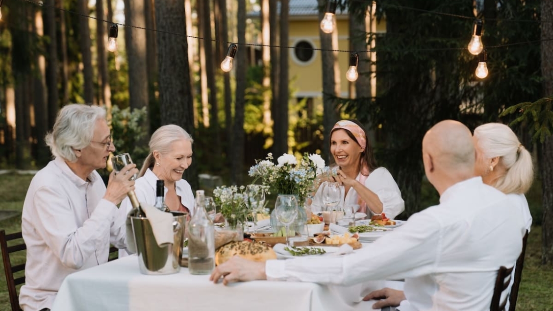 Elders sitting at an outdoor dining table to show healthy eating for seniors