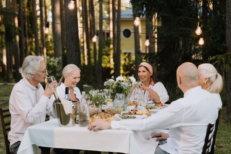 Elders sitting at an outdoor dining table to show healthy eating for seniors