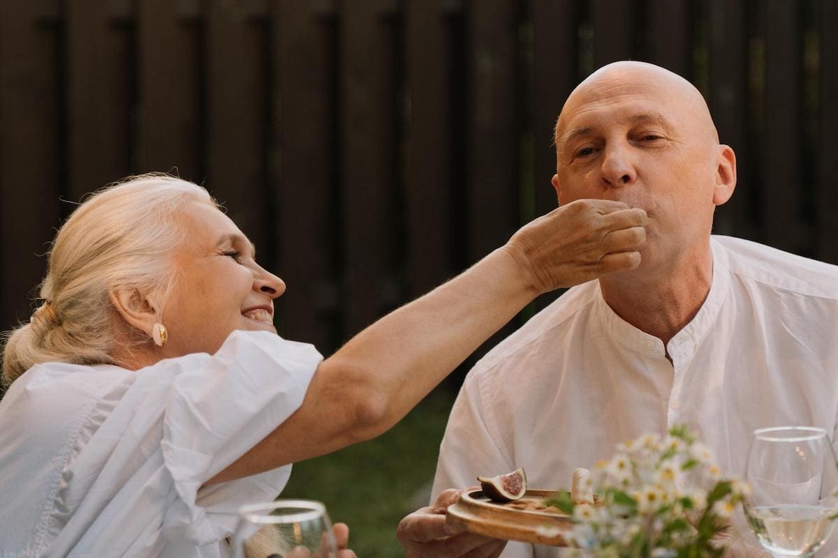 Woman feeding man for healthy eating for seniors