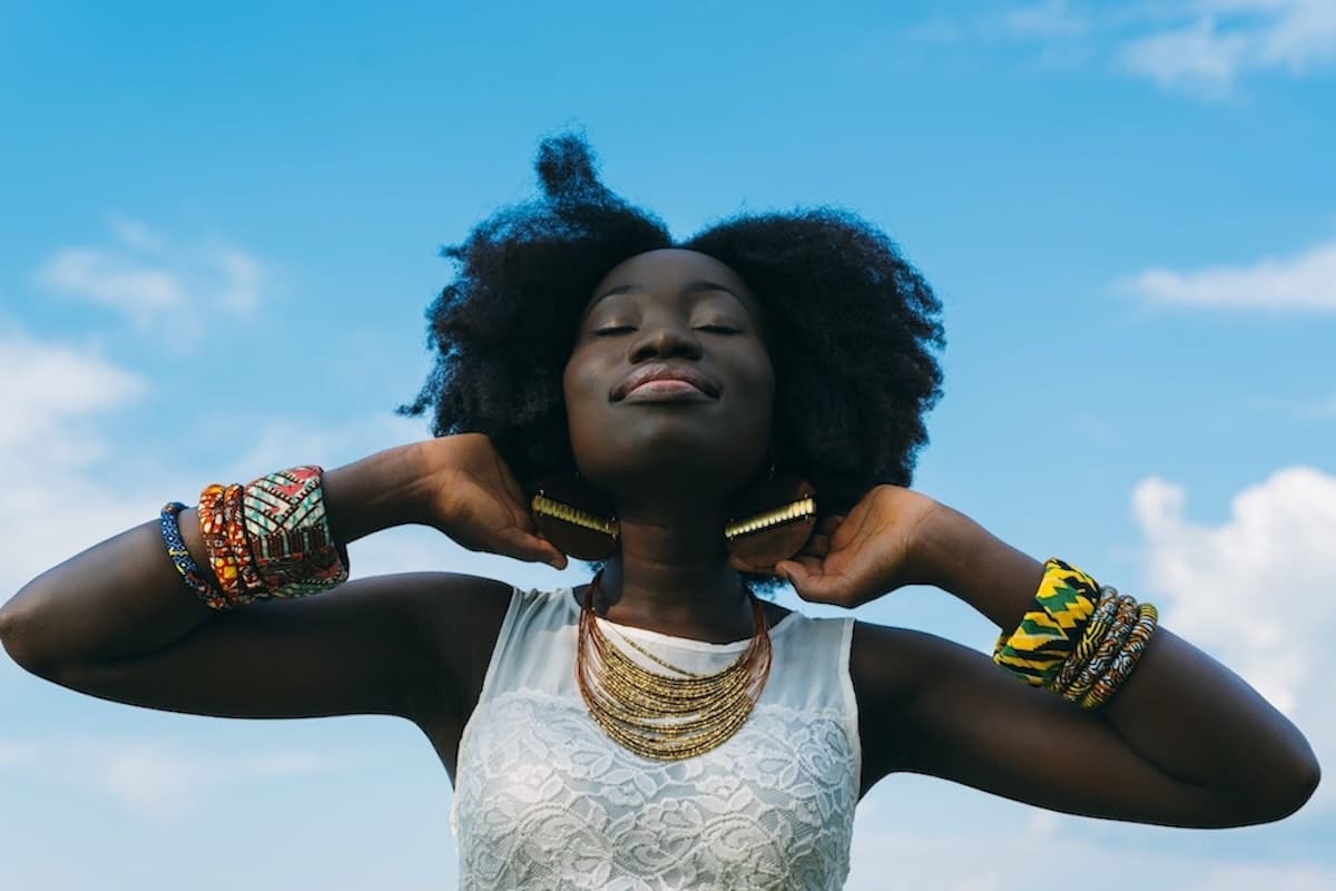 Woman looking up to the sky and working on her manifestation