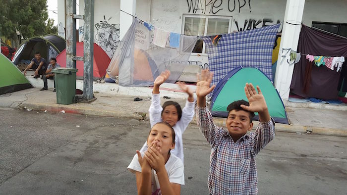 refugees blowing kisses