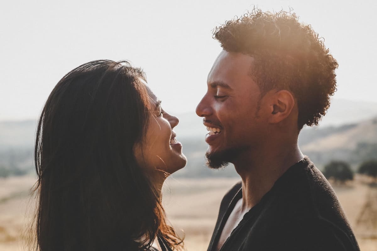 Couple facing each other and laughing