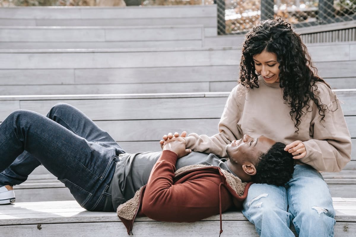 Man laying on woman's lap as part of the dating advice for men