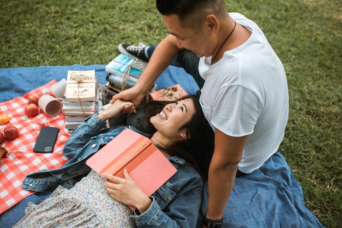 Woman laying on man's lap as part of the dating advice for men