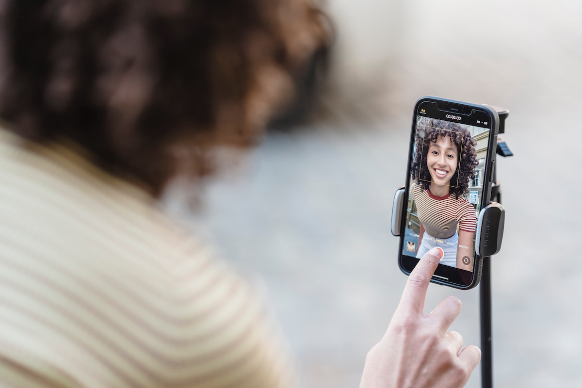 Woman recording herself on her phone to show how to go viral.