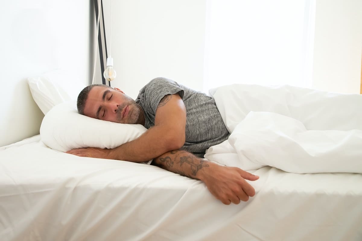 Man sleeping on his side in bed