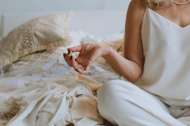 Woman meditating on a bed