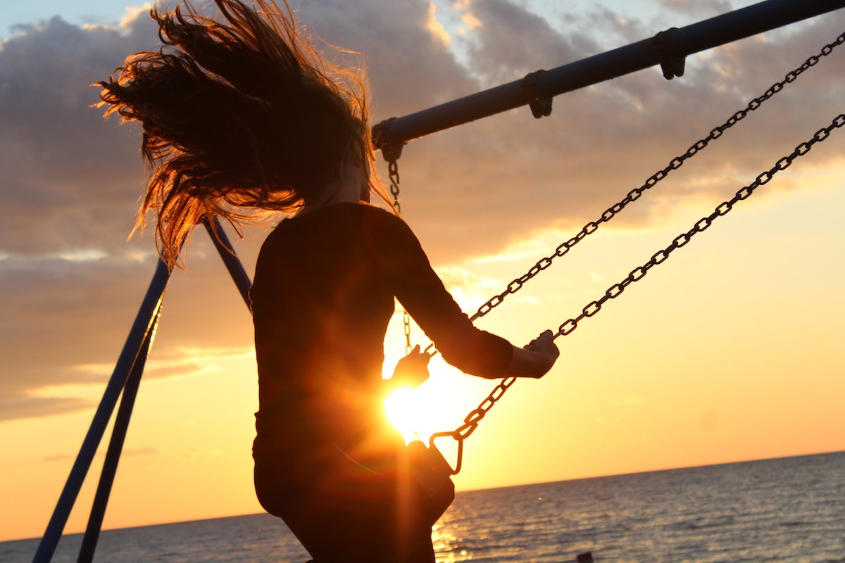 a woman swinging on a swing