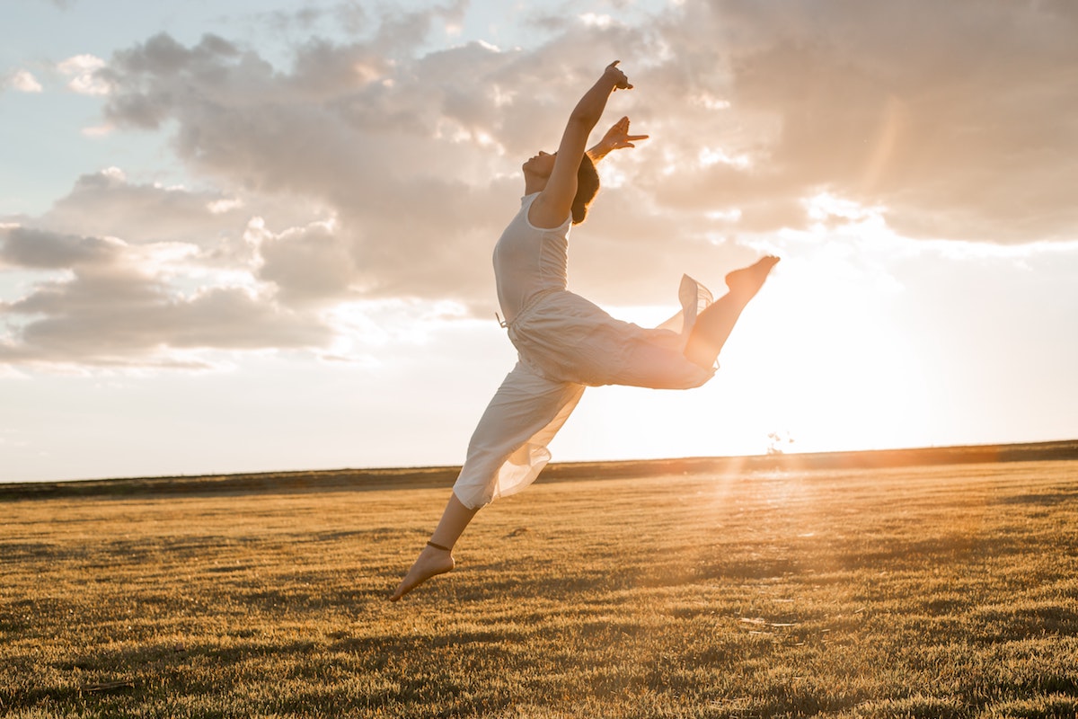 a woman dancing in the open field