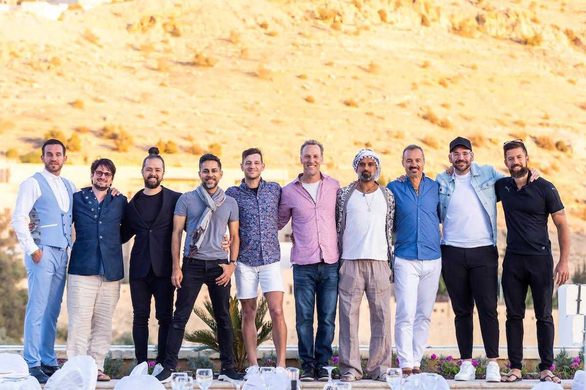 Men learning how to pose for pictures at Mindvalley's A-Fest 2022 in Jordan
