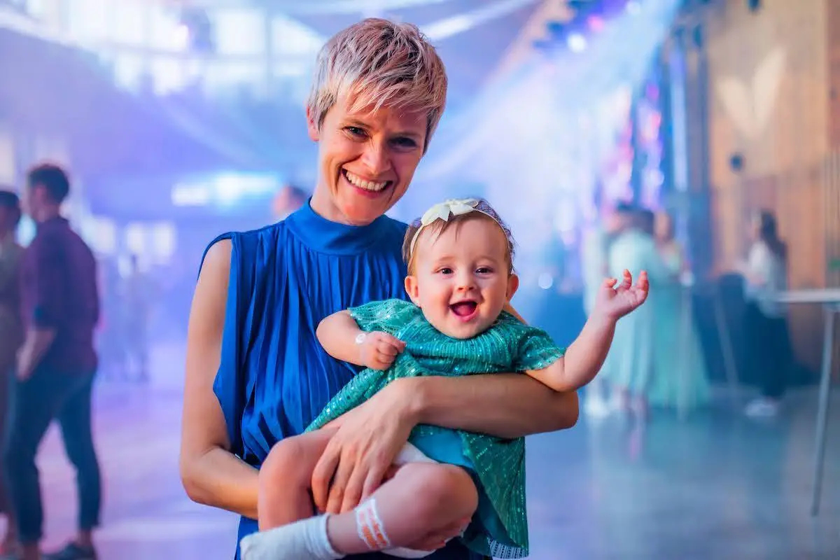 Woman with her baby at a Mindvalley event