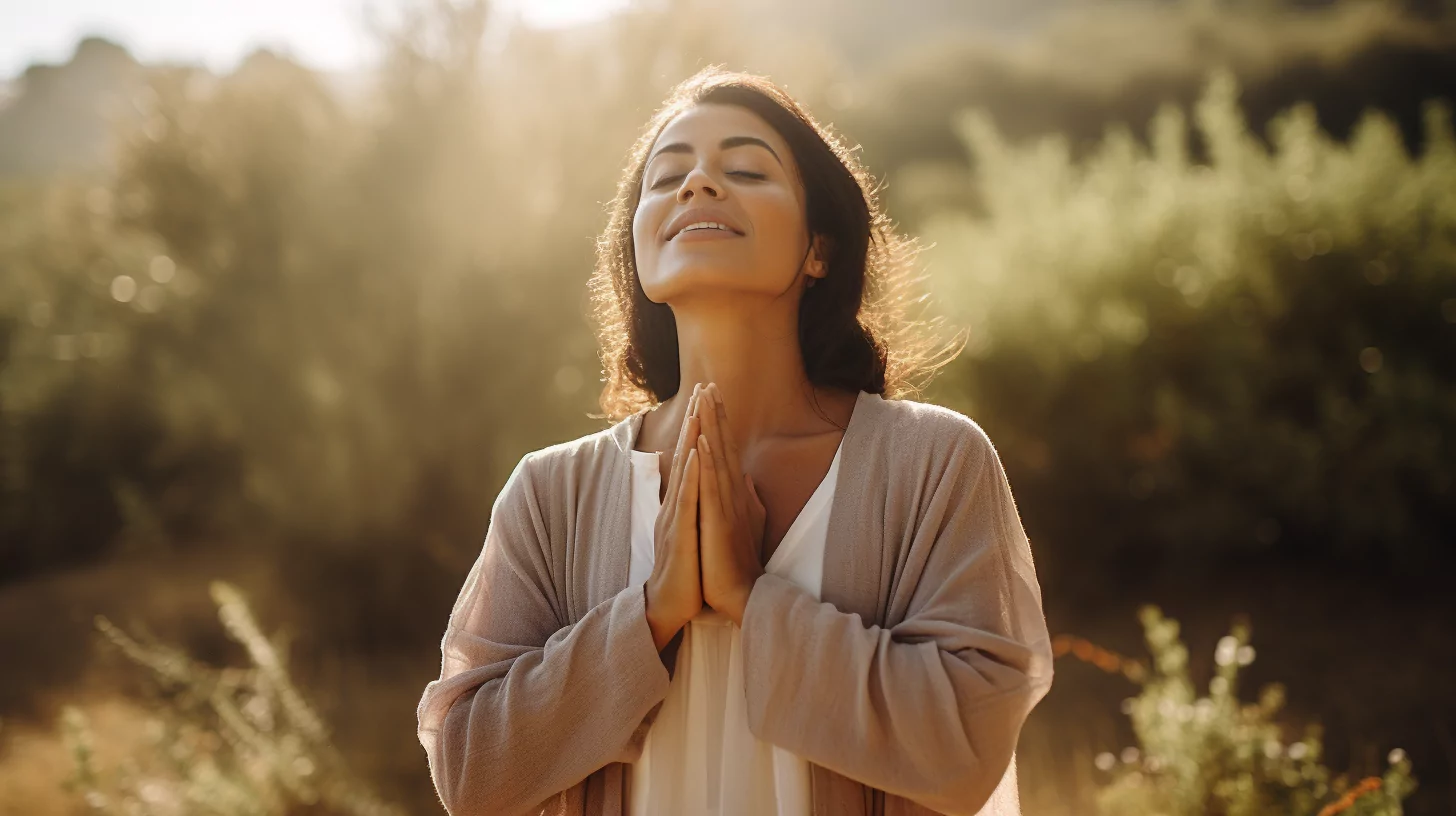A woman in prayer pose to go through the personal transformation stages