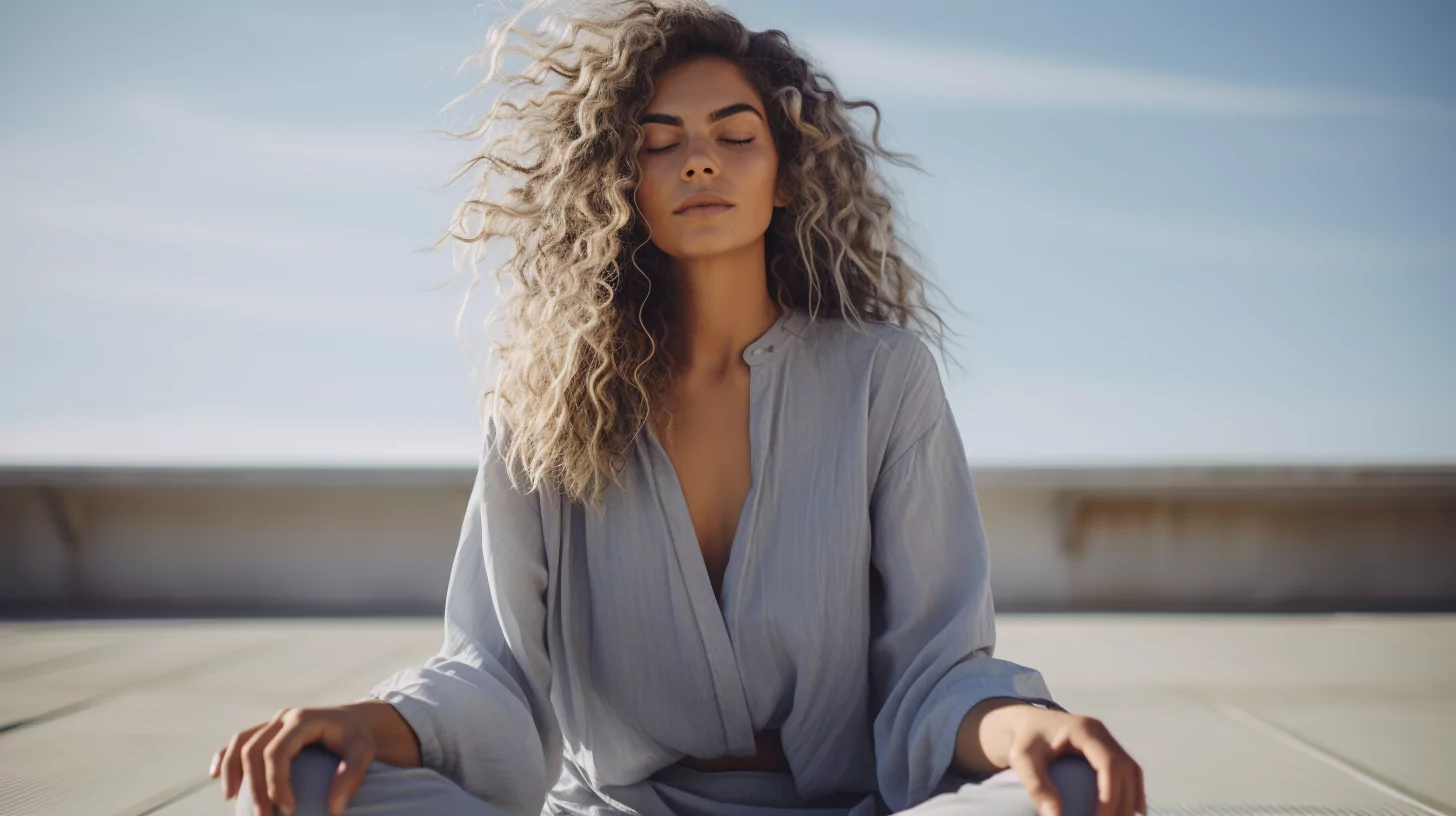 A woman meditating outdoors