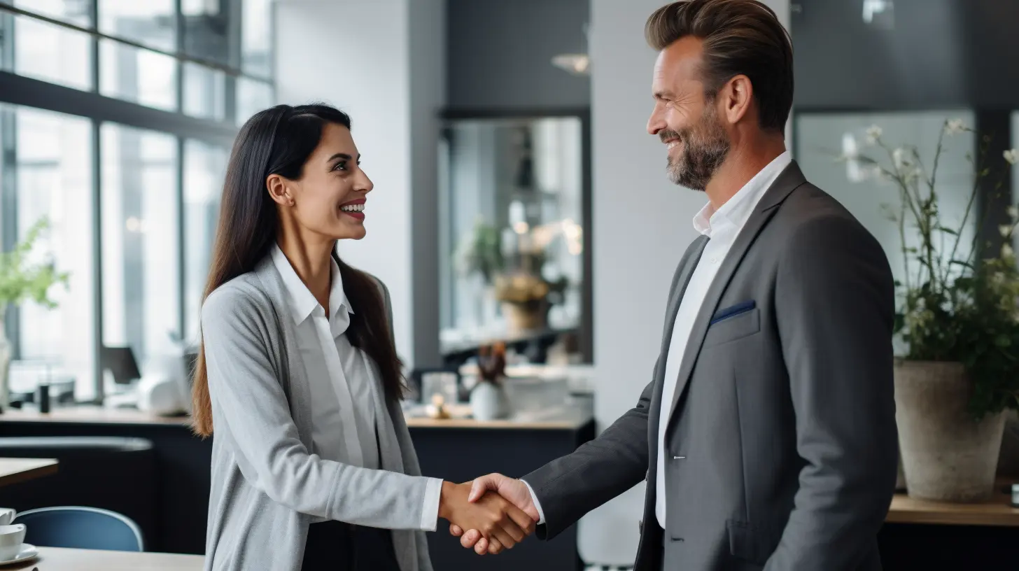 A man and woman shaking hands at a networking event