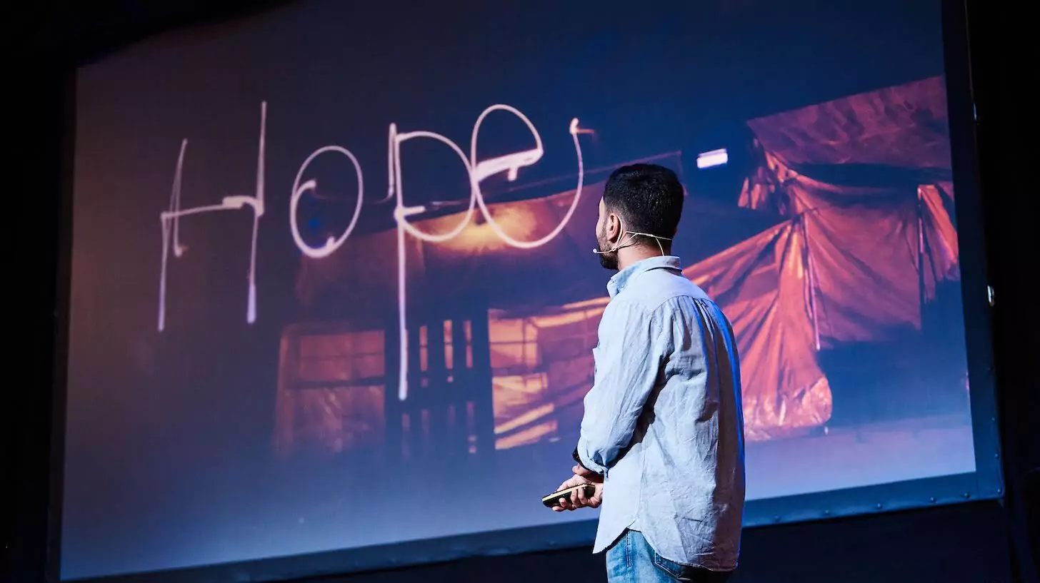 A man presenting a positive affirmation on a screen