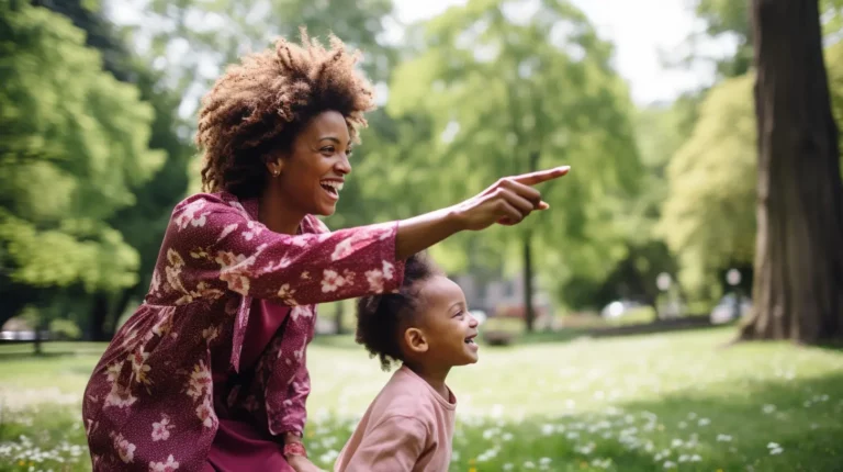 A mother pointing at something in the distance while her child looks