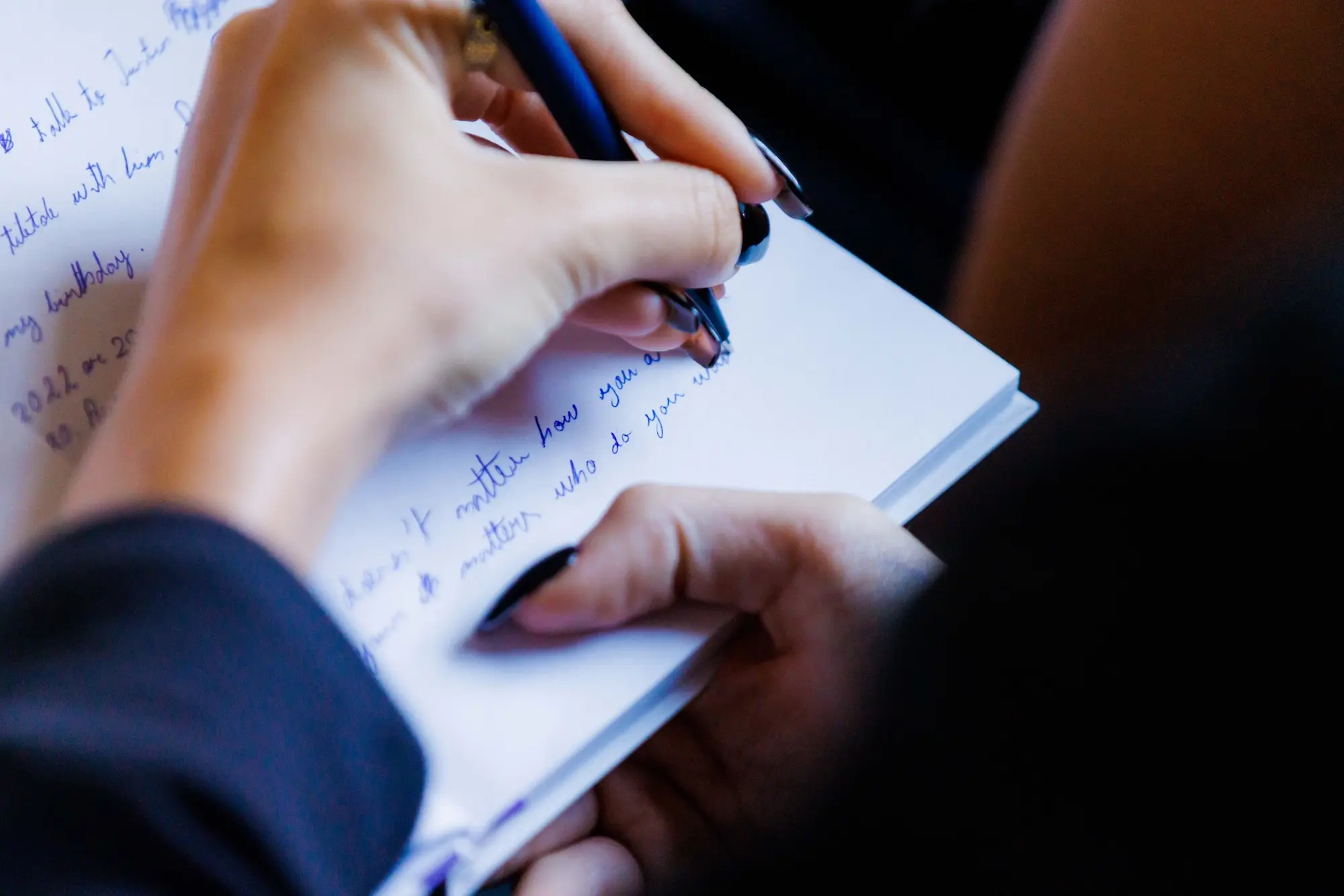 A woman using scripting manifestation in a journal