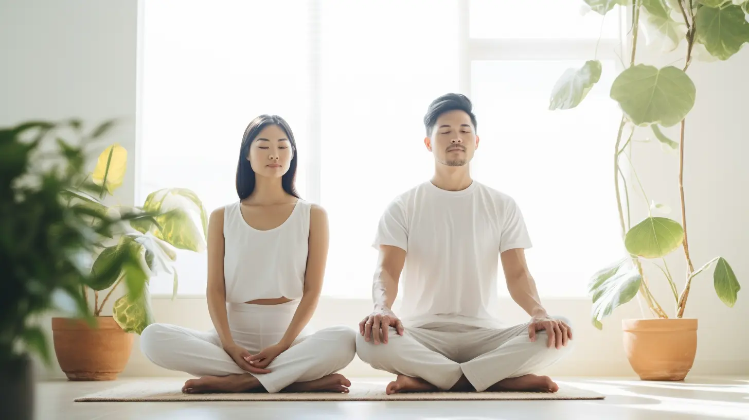 A couple sits cross-legged together in meditation