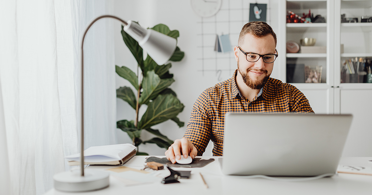 Guy sitting at a desk working on his computer