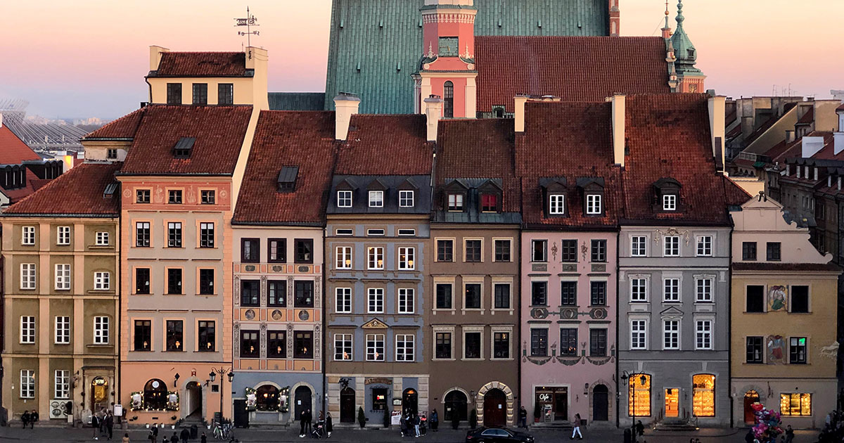 The colorful houses in Warsaw, Poland at sunset.