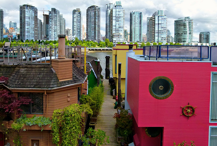 Houses with skyscrapers across water in background