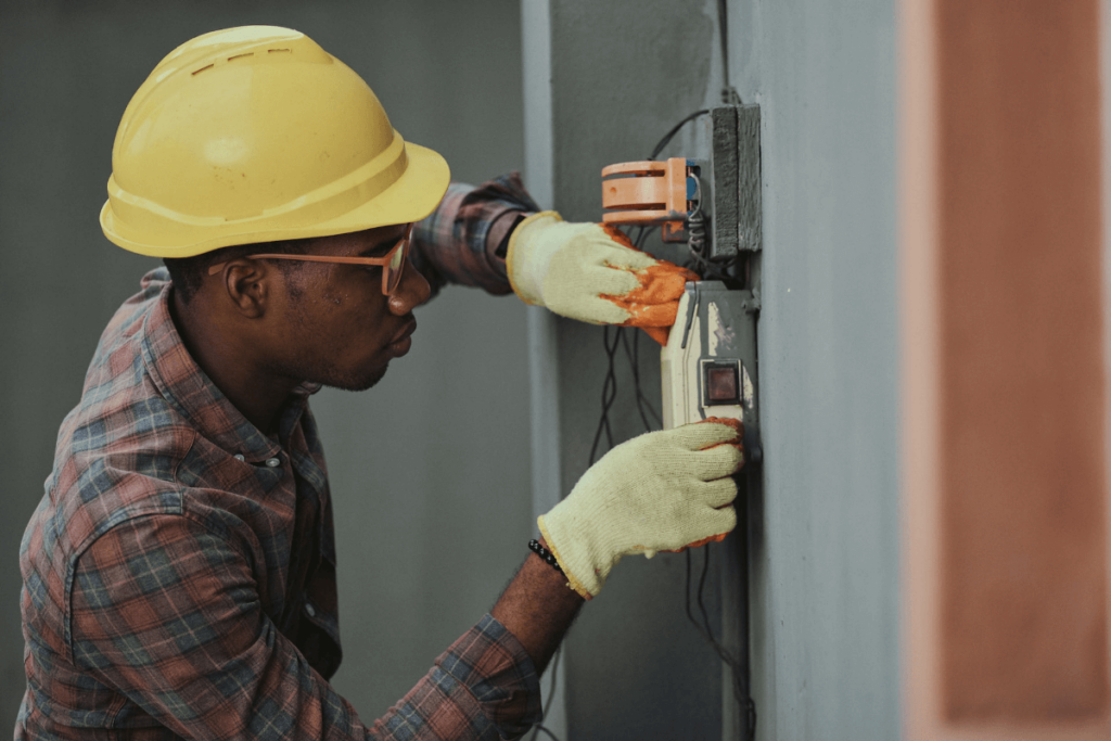 A construction worker examines wiring meets electrical licenses standards