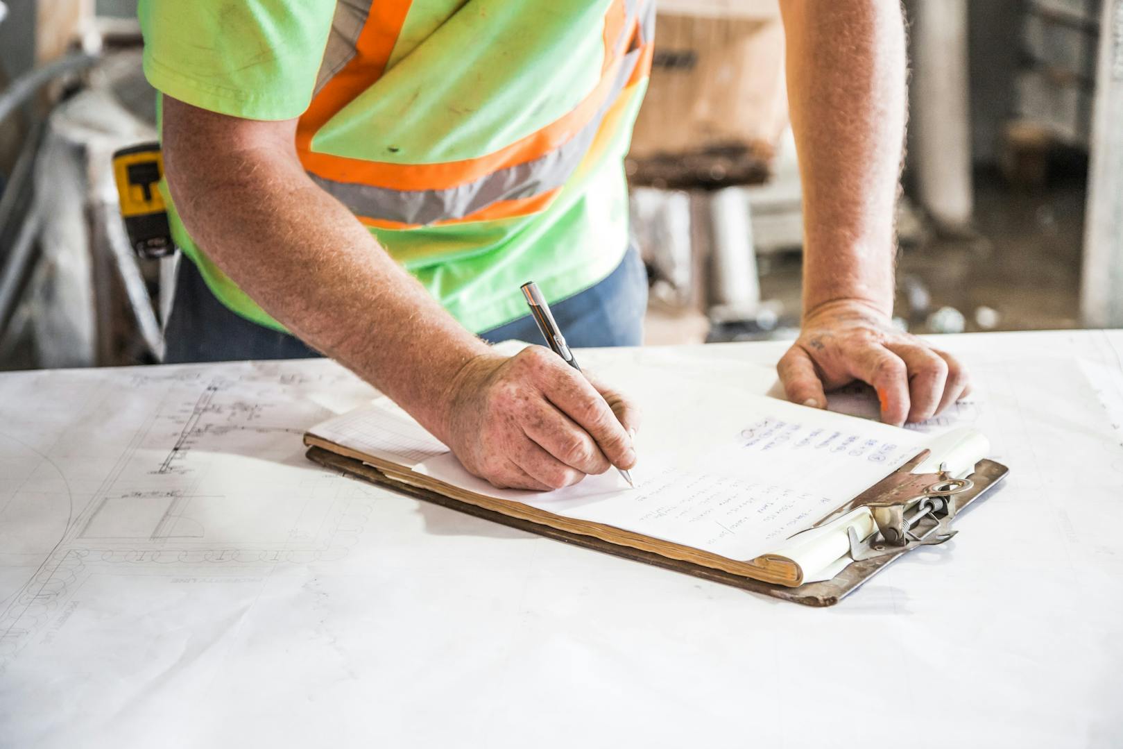 Construction project manager Edison NJ PM reviewing plans on construction site