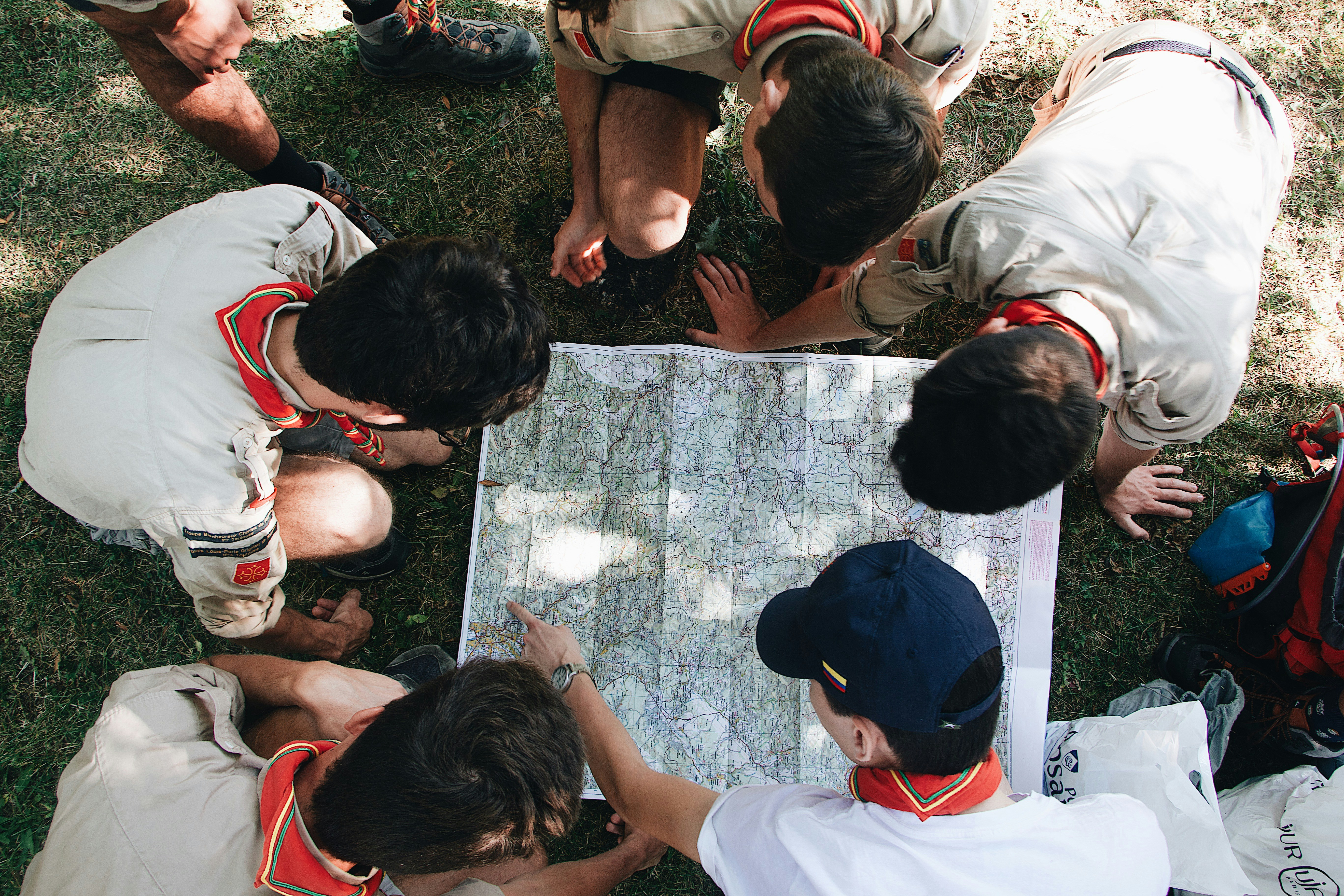 A group of young people working together on a community clean-up project in a park.