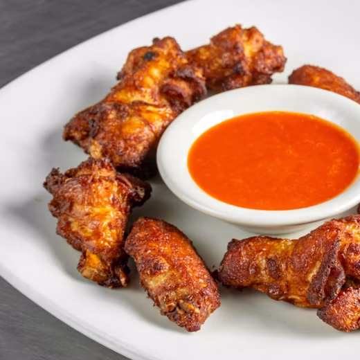 Chicken wings tossed and ready to serve