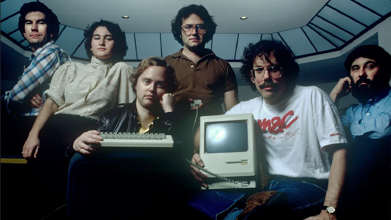 The original Macintosh team at Apple posing with the first Macintosh computer, 1984