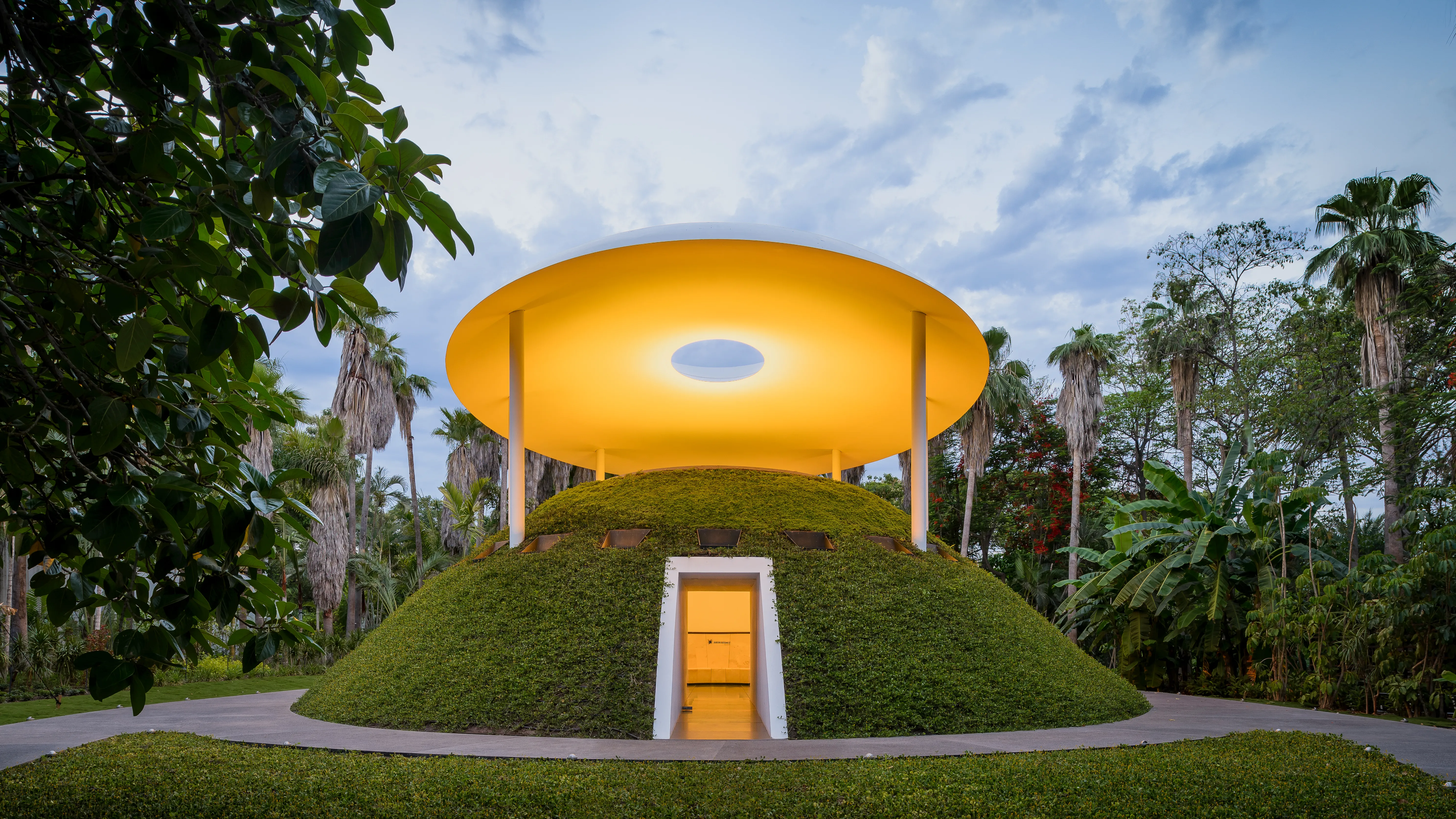James Turrell, Encounter - a golden disc-shaped Skyspace nestled in tropical gardens