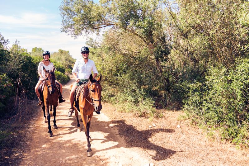 light and breathable fabrics for clothes in summer Italy, couple riding a horse