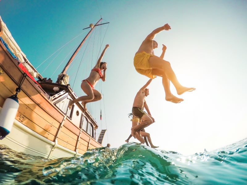 people jumping in the water, swimming at the sea Italy